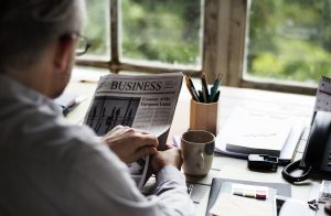businesspeople-reading-newspaper-at-office-updating-news.jpg